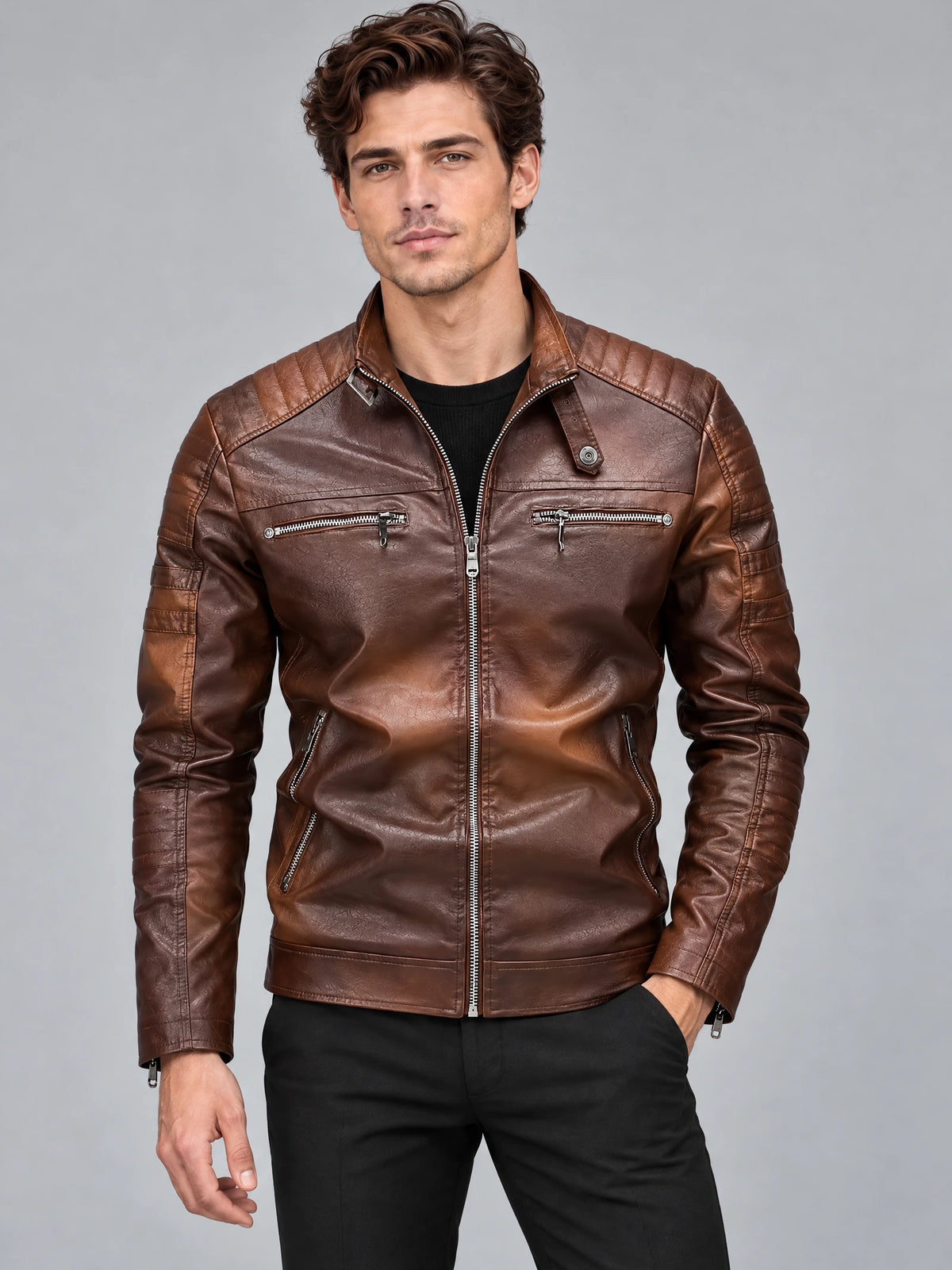 Front studio view of a model wearing a Brown Biker Leather Jacket with quilted shoulder panels and zippered pockets.