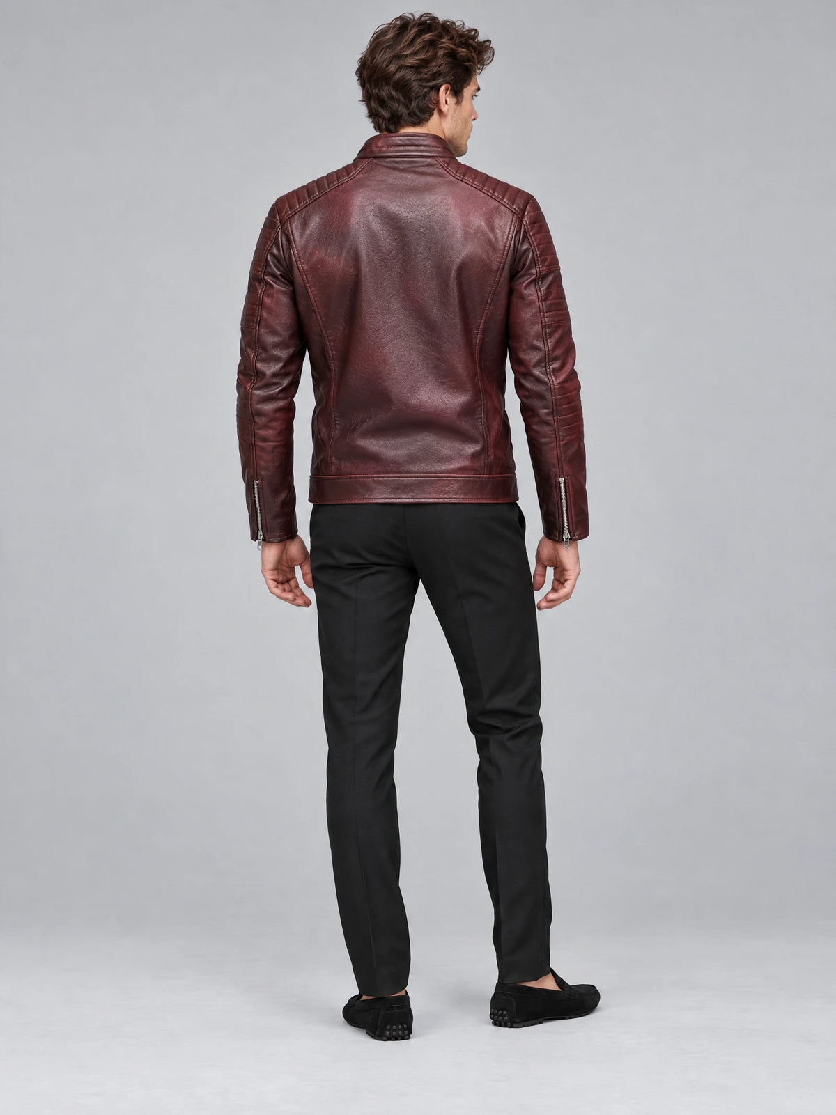 Rear studio view of a model wearing a Red Biker Leather Jacket with quilted shoulder panels and zippered cuffs.