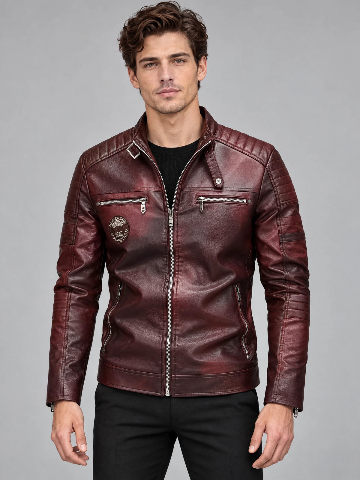 Front studio view of a model wearing a Red Biker Leather Jacket with quilted shoulders, zip chest pockets, and a stand collar.