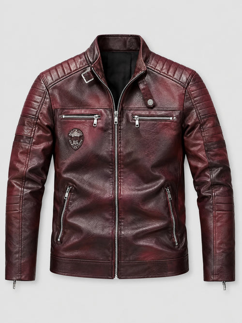 Red biker leather jacket laid flat, featuring a stand collar, quilted shoulder panels, and multiple zip pockets.