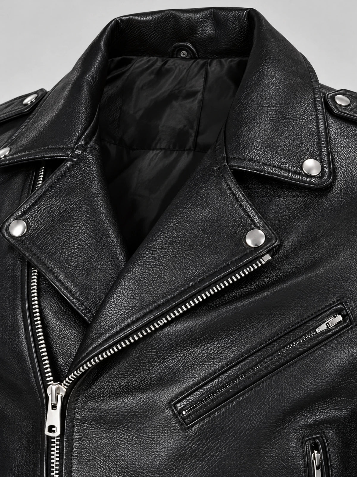 Close-up of a Black Biker Leather Jacket with textured PU leather, snap lapels, diagonal zipper, and zippered chest pocket.