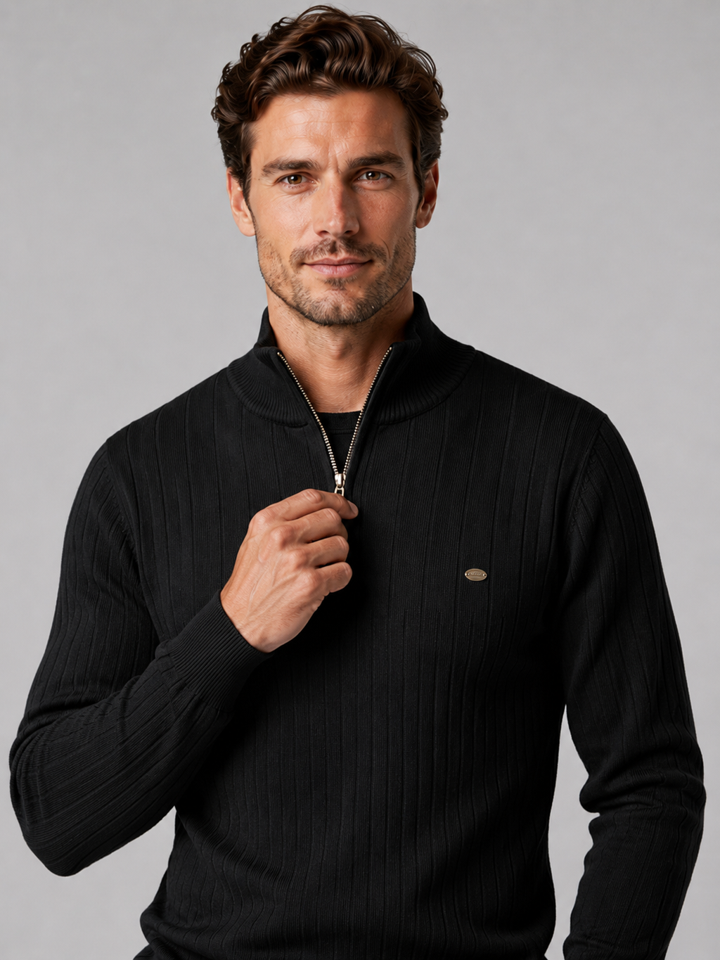 Close-up of a black quarter zip pullover sweater showing the cotton knit texture, stand collar, zipper placket, cuffs, hem, and stitching details