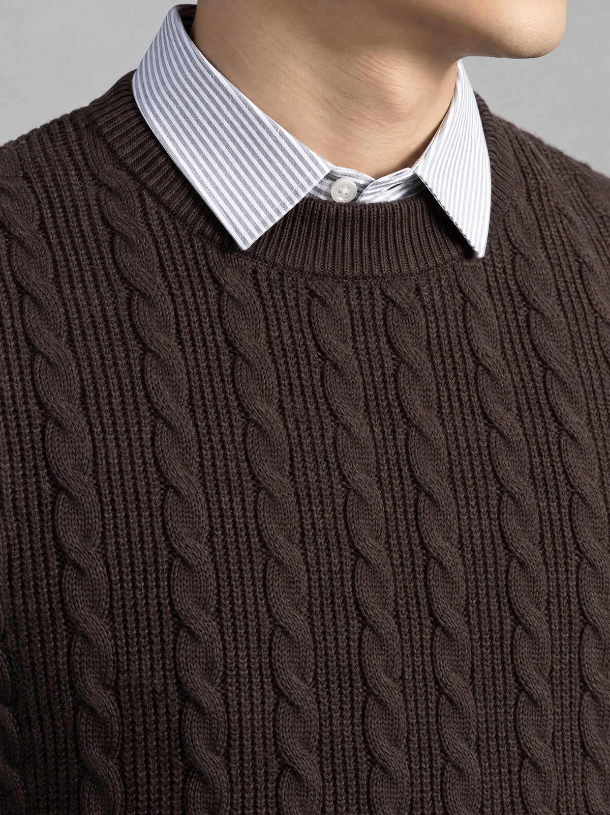 Brown business casual knitted pullover sweater close-up showing cable-knit texture and faux shirt collar detail.