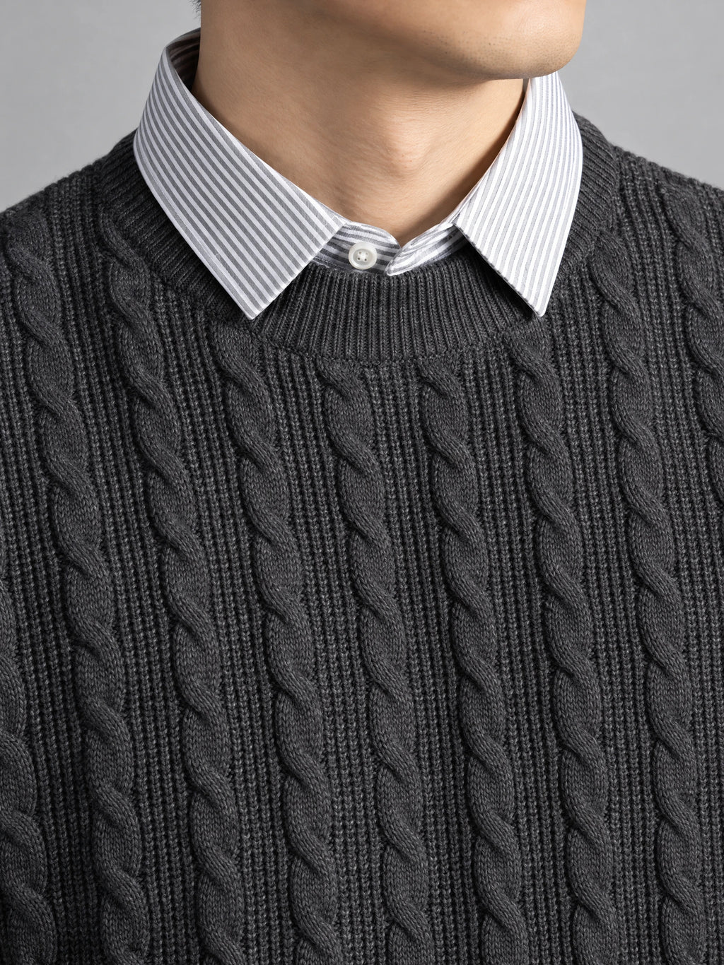 Close-up of a Charcoal business casual knitted pullover sweater with cable-knit texture and a faux striped shirt collar.