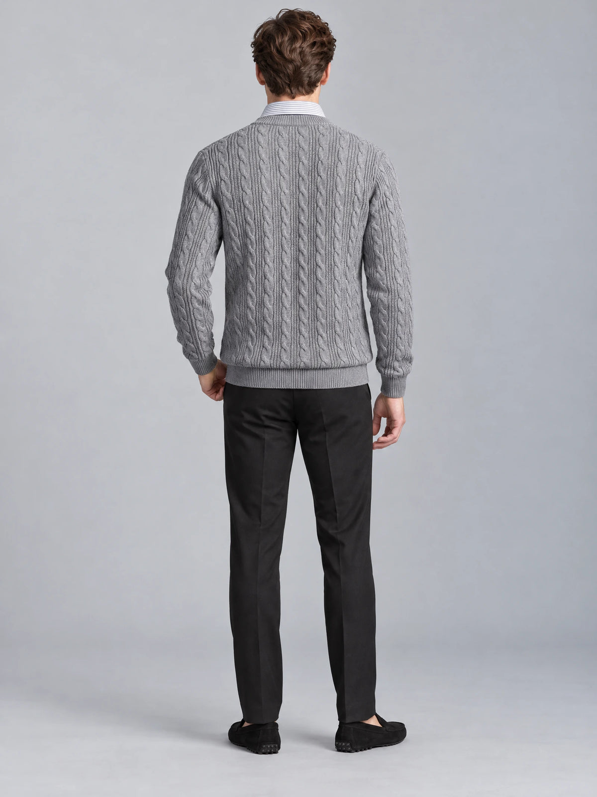 Rear studio view of a model wearing a Gray business casual knitted pullover sweater with a cable-knit back and shirt-style collar.