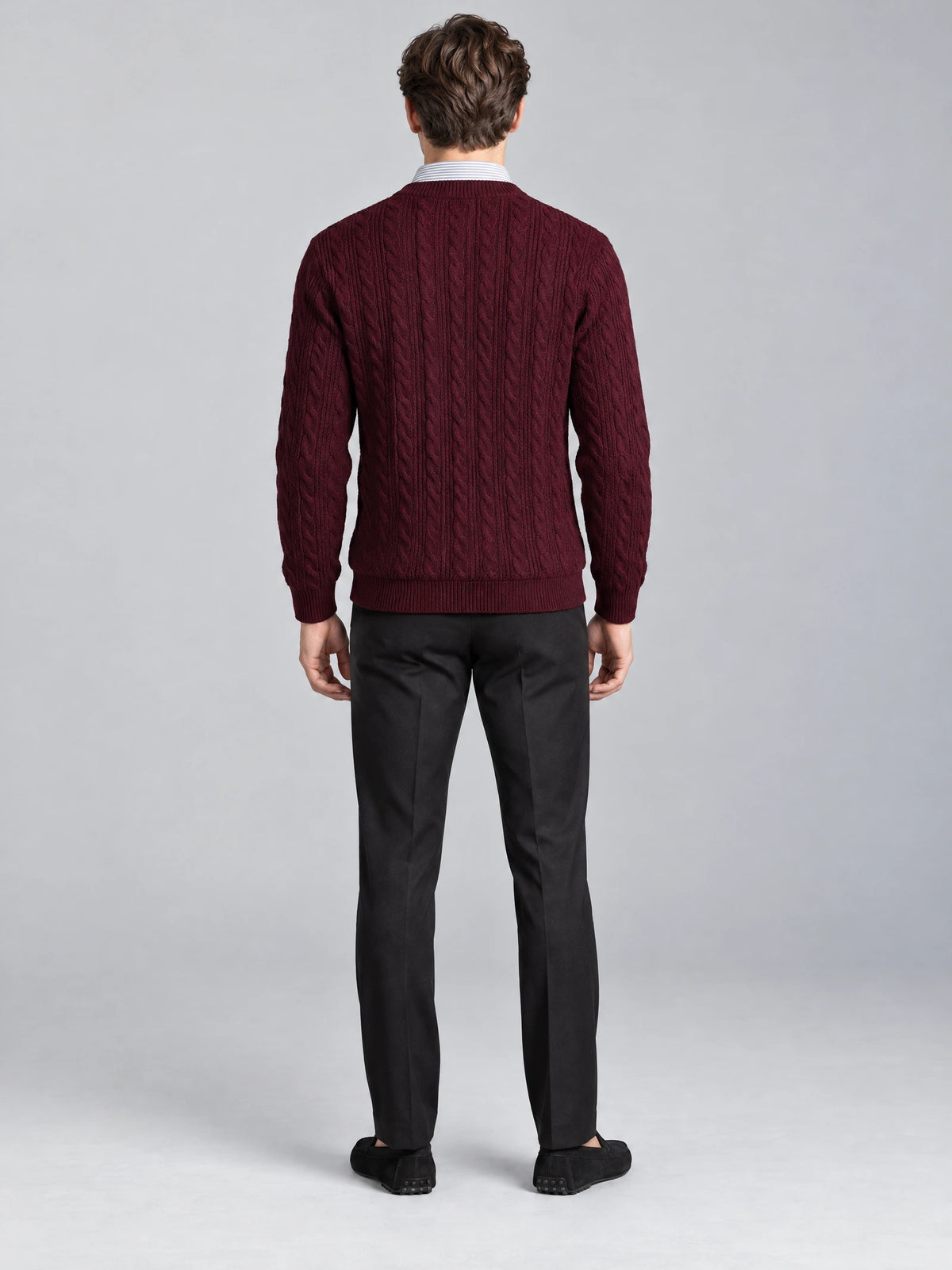 Rear view of a model wearing a Wine business casual knitted pullover sweater with vertical cable-knit texture and ribbed trim.