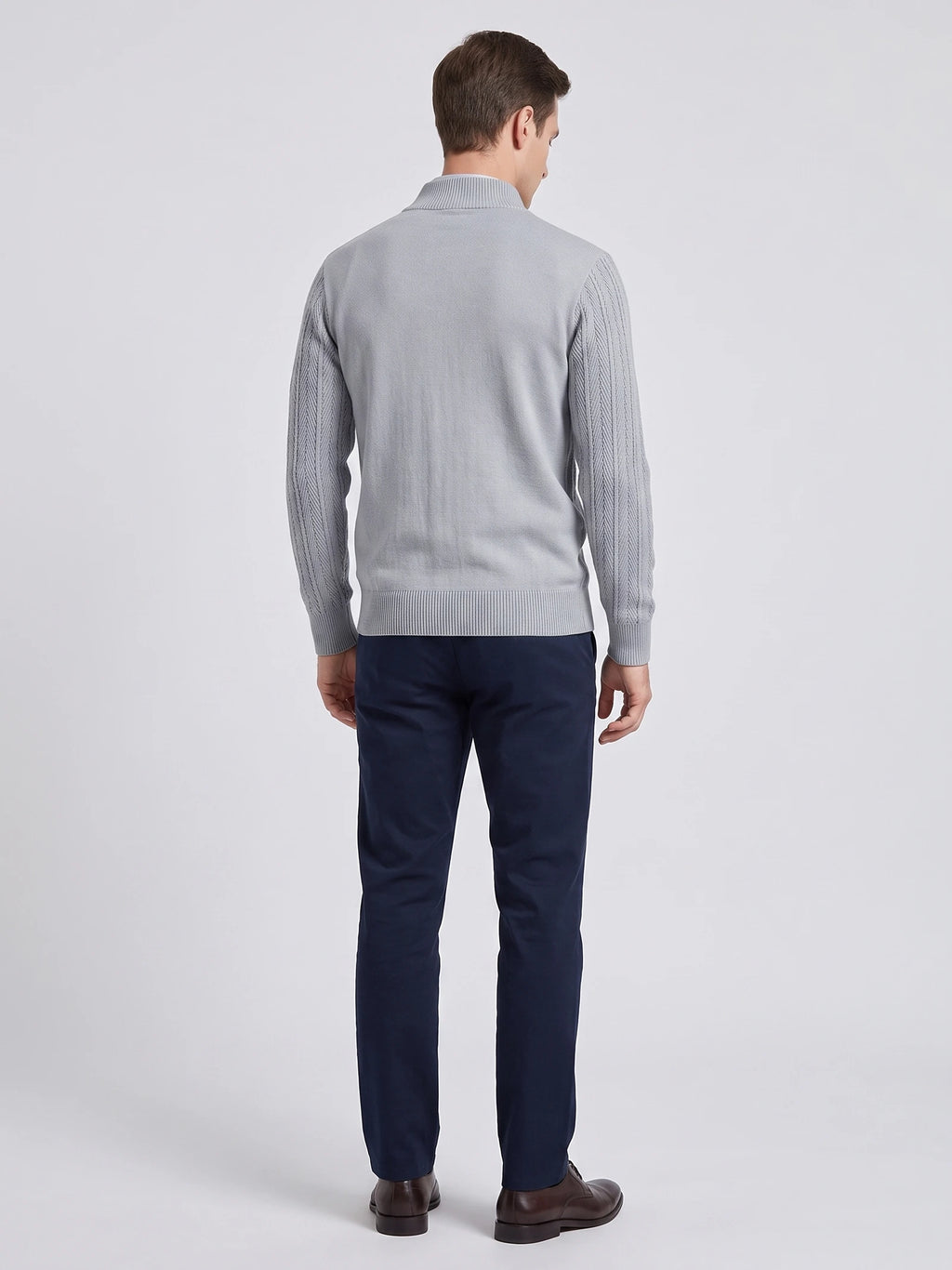 Rear studio view of a model wearing a Gray Button Up Cardigan with textured knit sleeves, ribbed stand collar, cuffs, and hem.
