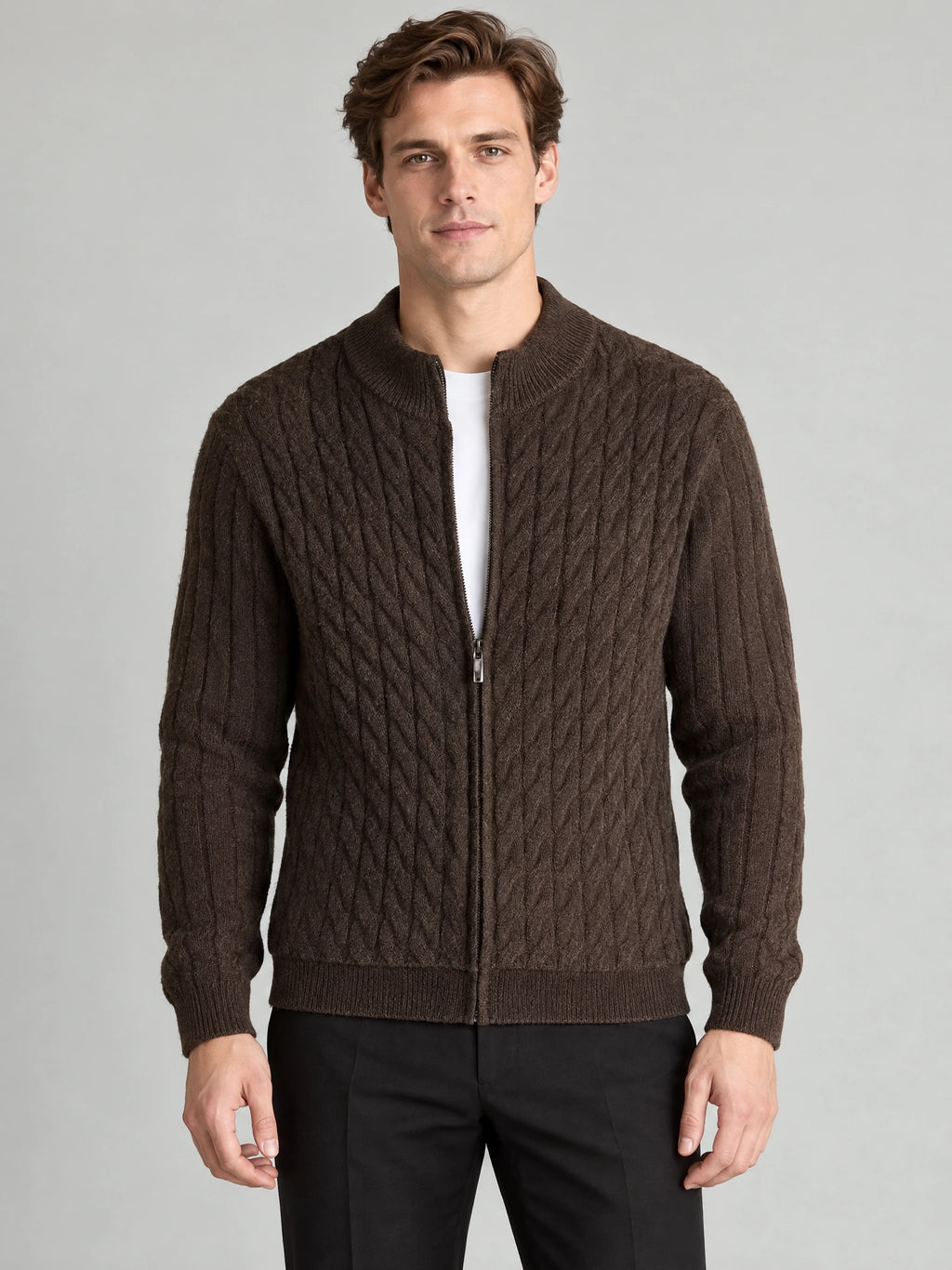 Front studio view of a model wearing a Brown cable knit full zip sweater with a ribbed stand collar.