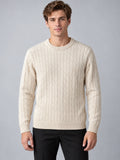 Front studio view of a model wearing a Beige cable knit sweater with a ribbed crewneck, cuffs, and hem.