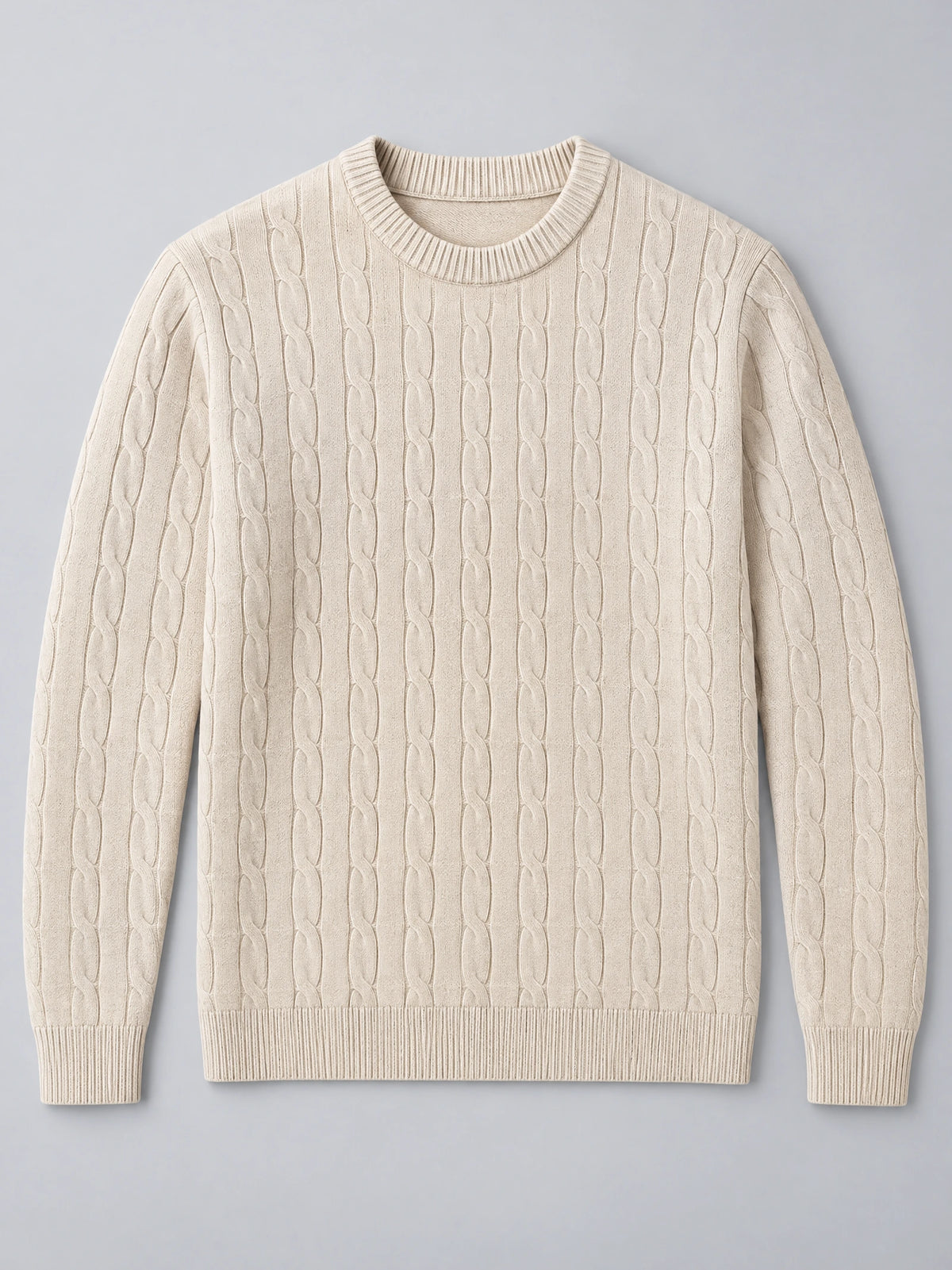 Beige cable knit sweater laid flat, featuring a ribbed crewneck, cuffs, and hem.