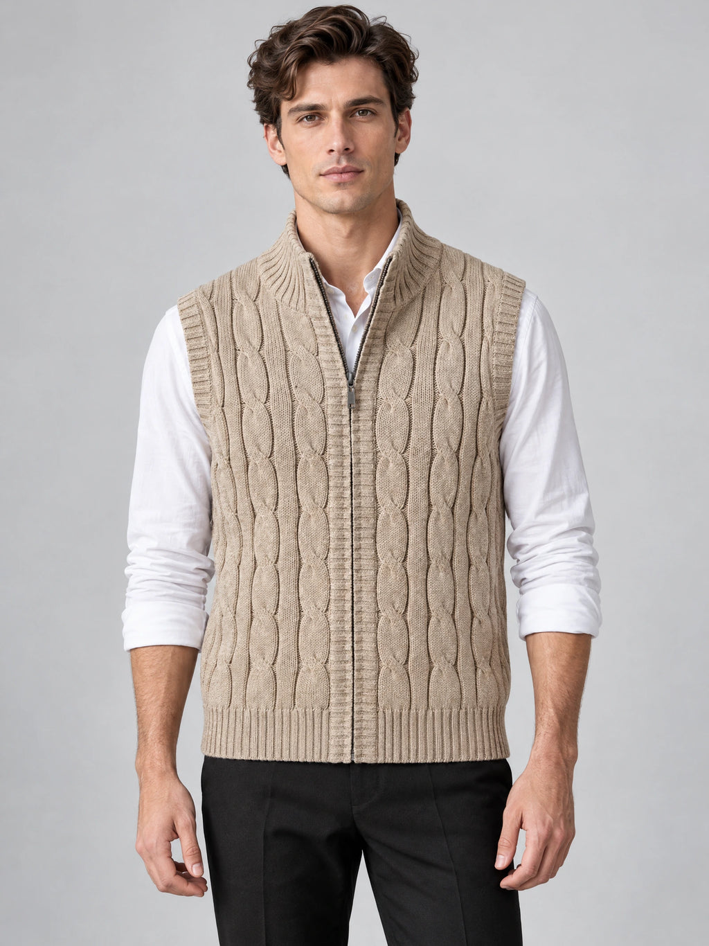 Front studio view of a model wearing a Khaki cable knit sweater vest with a ribbed half-zip collar.