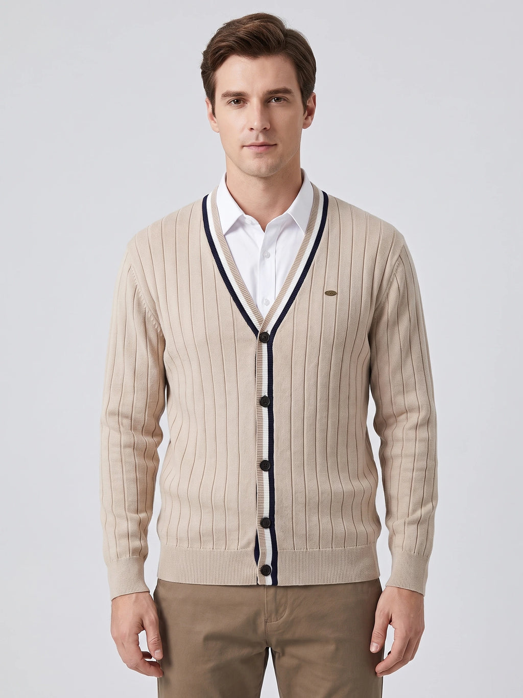 Front studio view of a model wearing a Beige cotton Cardigan Sweater with a ribbed V-neck, button front, and vertical knit texture.