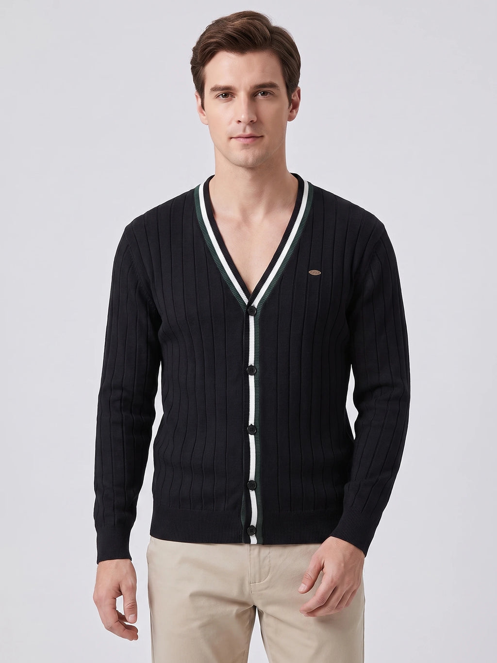 Front studio view of a model wearing a Black cotton Cardigan Sweater with a V-neck, button front, and ribbed knit texture.