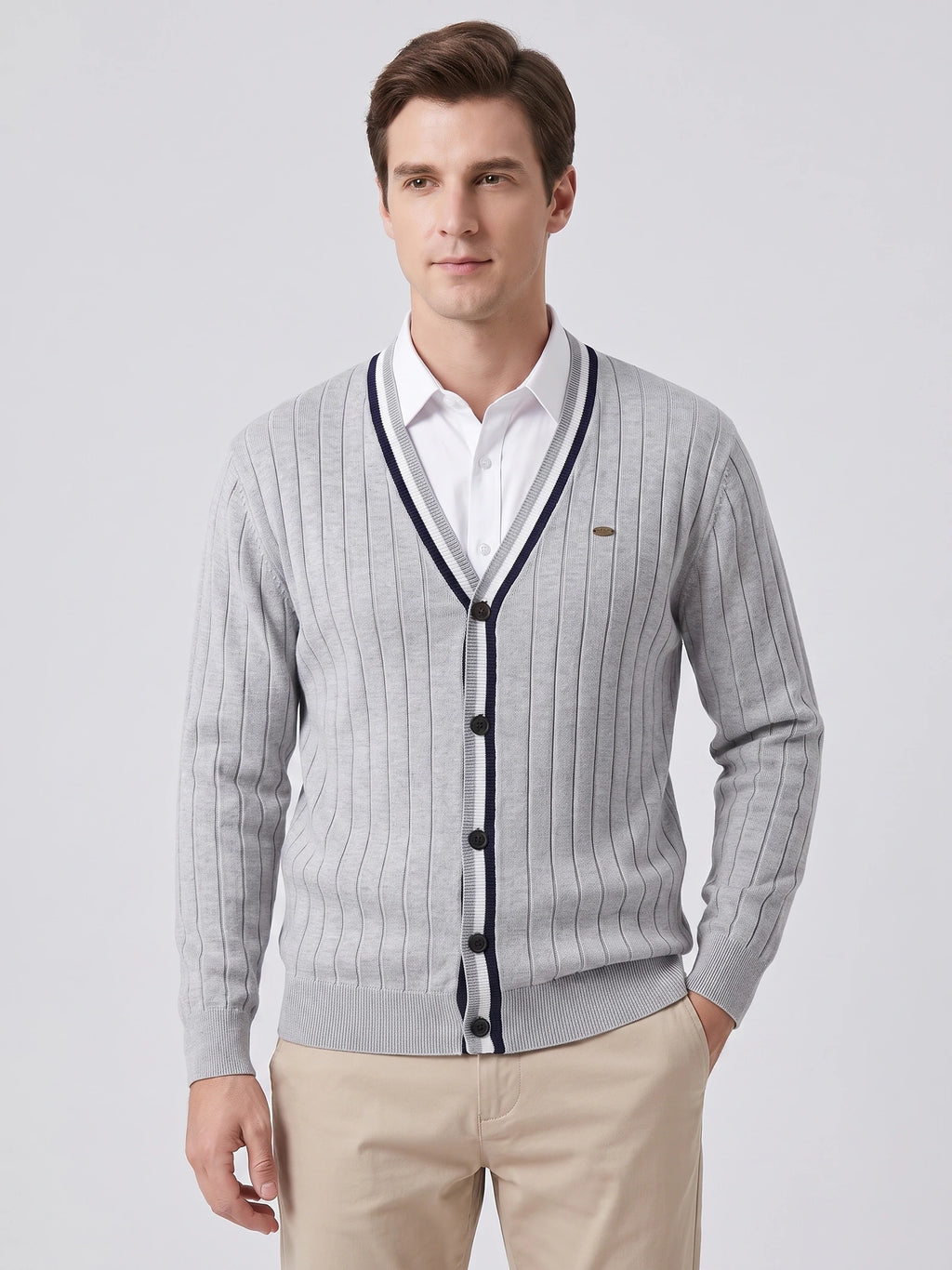 Front studio view of a model wearing a Gray cotton Cardigan Sweater with a V-neck, button front, and vertical knit texture.