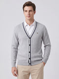 Front studio view of a model wearing a Gray cotton Cardigan Sweater with a V-neck, button front, and vertical knit texture.