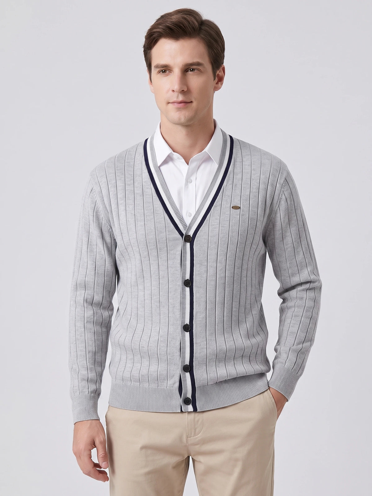 Front studio view of a model wearing a Gray cotton Cardigan Sweater with a V-neck, button front, and vertical knit texture.