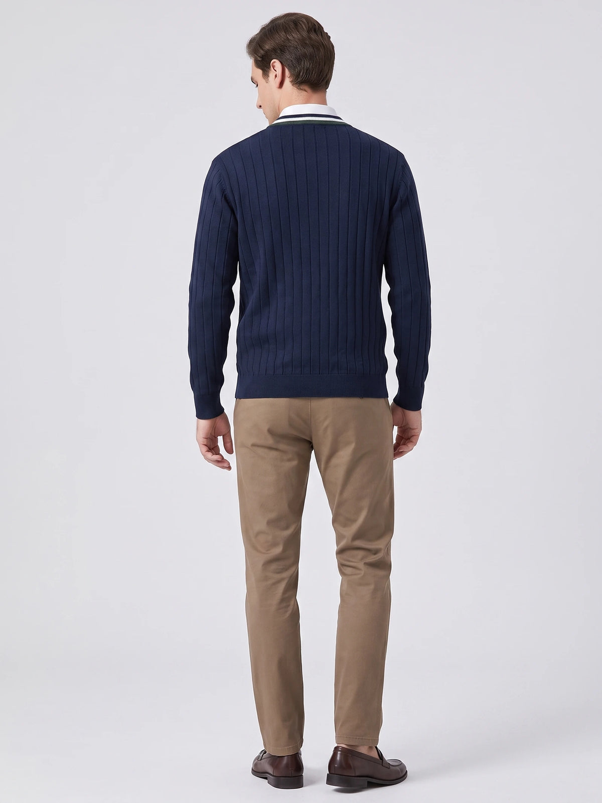 Rear studio view of a model wearing a Navy cotton Cardigan Sweater with vertical ribbed knit texture.