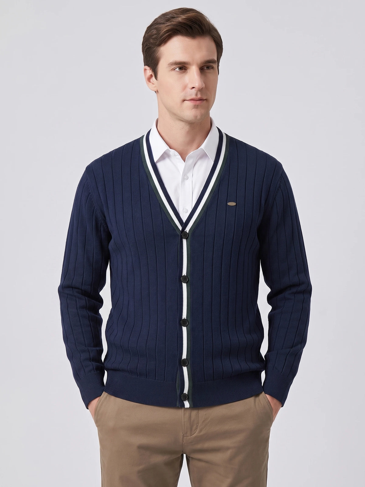 Front studio view of a model wearing a Navy cotton Cardigan Sweater with a ribbed V-neck and button front.