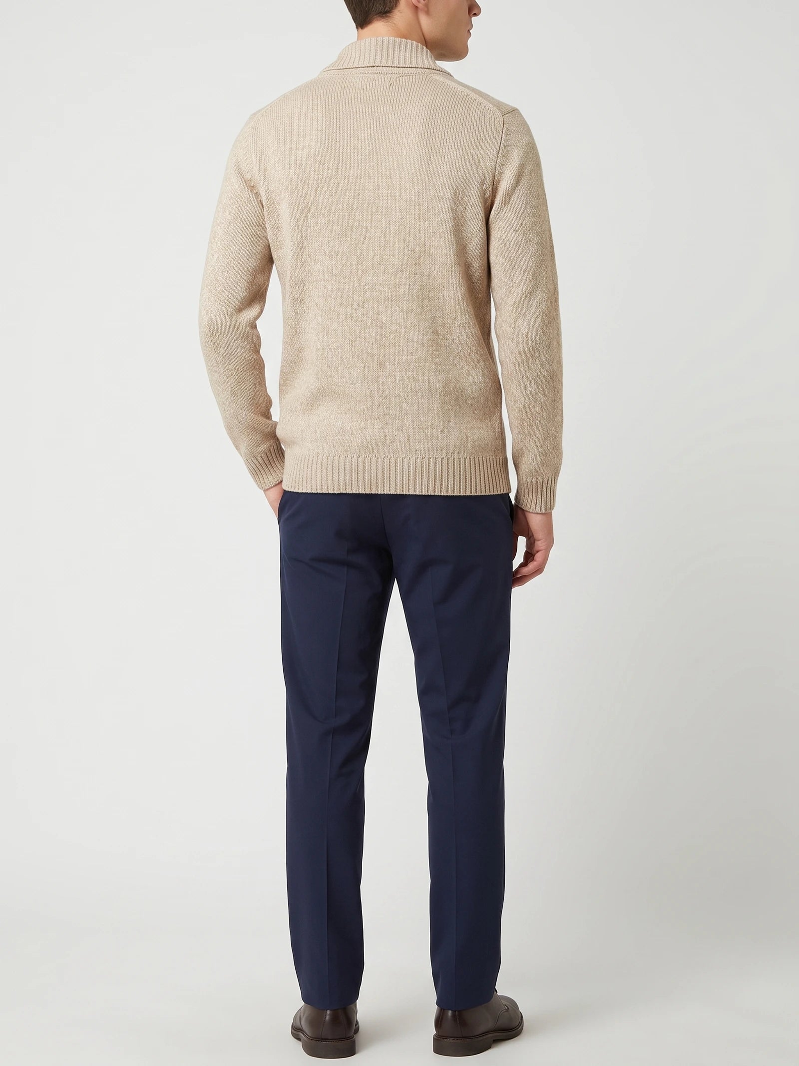 Rear studio view of a model wearing a Beige Cardigan Sweater with ribbed collar, cuffs, and hem.