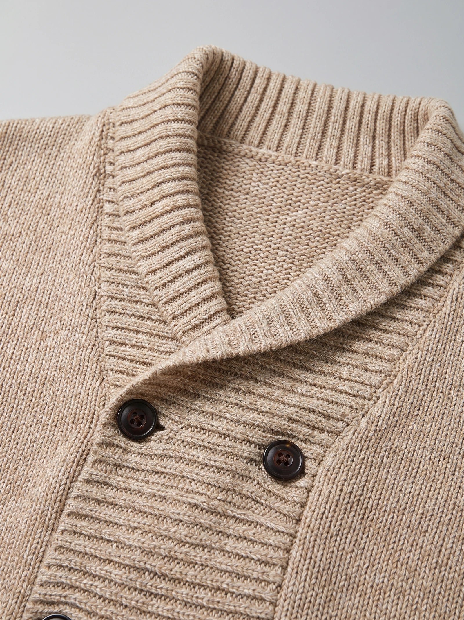 Close-up of the Beige men's Cardigan Sweater with a ribbed shawl collar, textured knit, and double-button front.