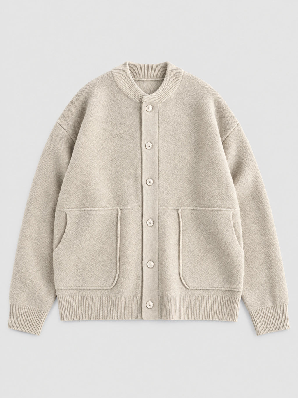 Beige wool Cardigan Sweater laid flat, featuring a ribbed round neck, button front, and two patch pockets.