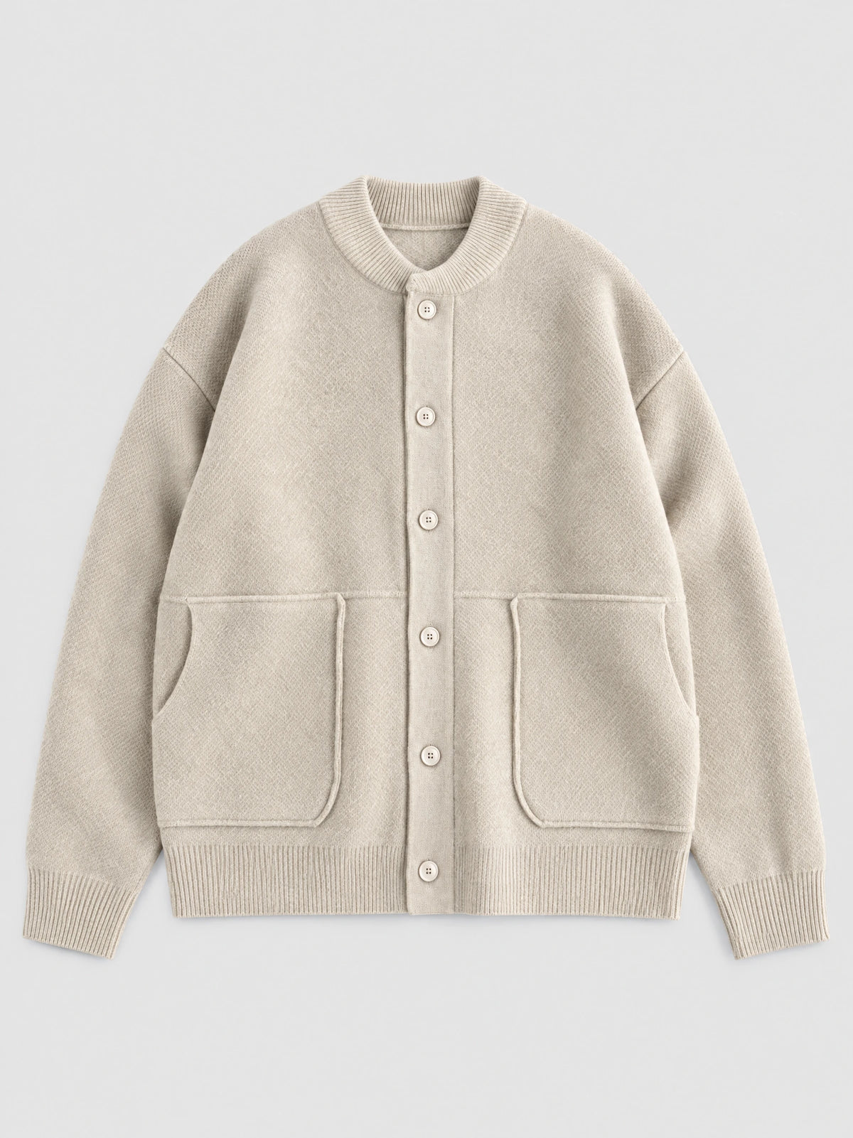 Beige wool Cardigan Sweater laid flat, featuring a ribbed round neck, button front, and two patch pockets.