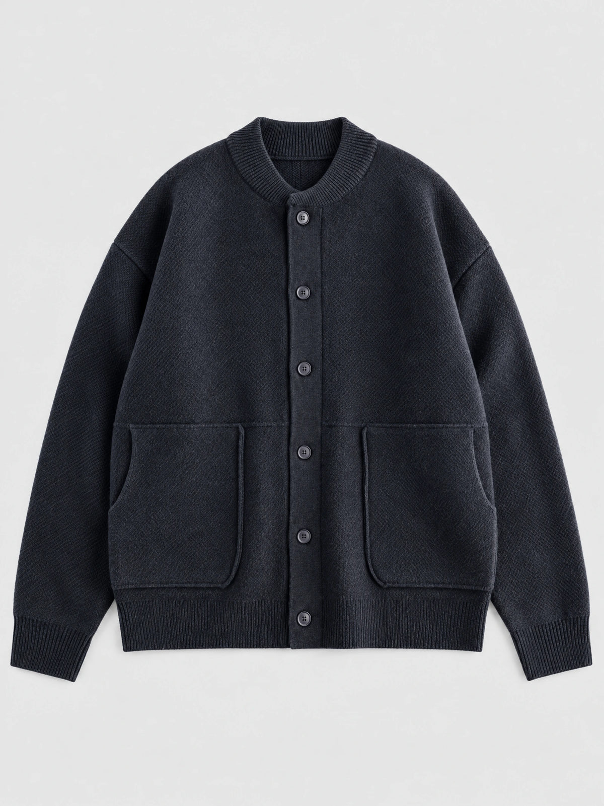 Navy wool Cardigan Sweater laid flat, featuring a ribbed round neckline, button-front closure, and two patch pockets.