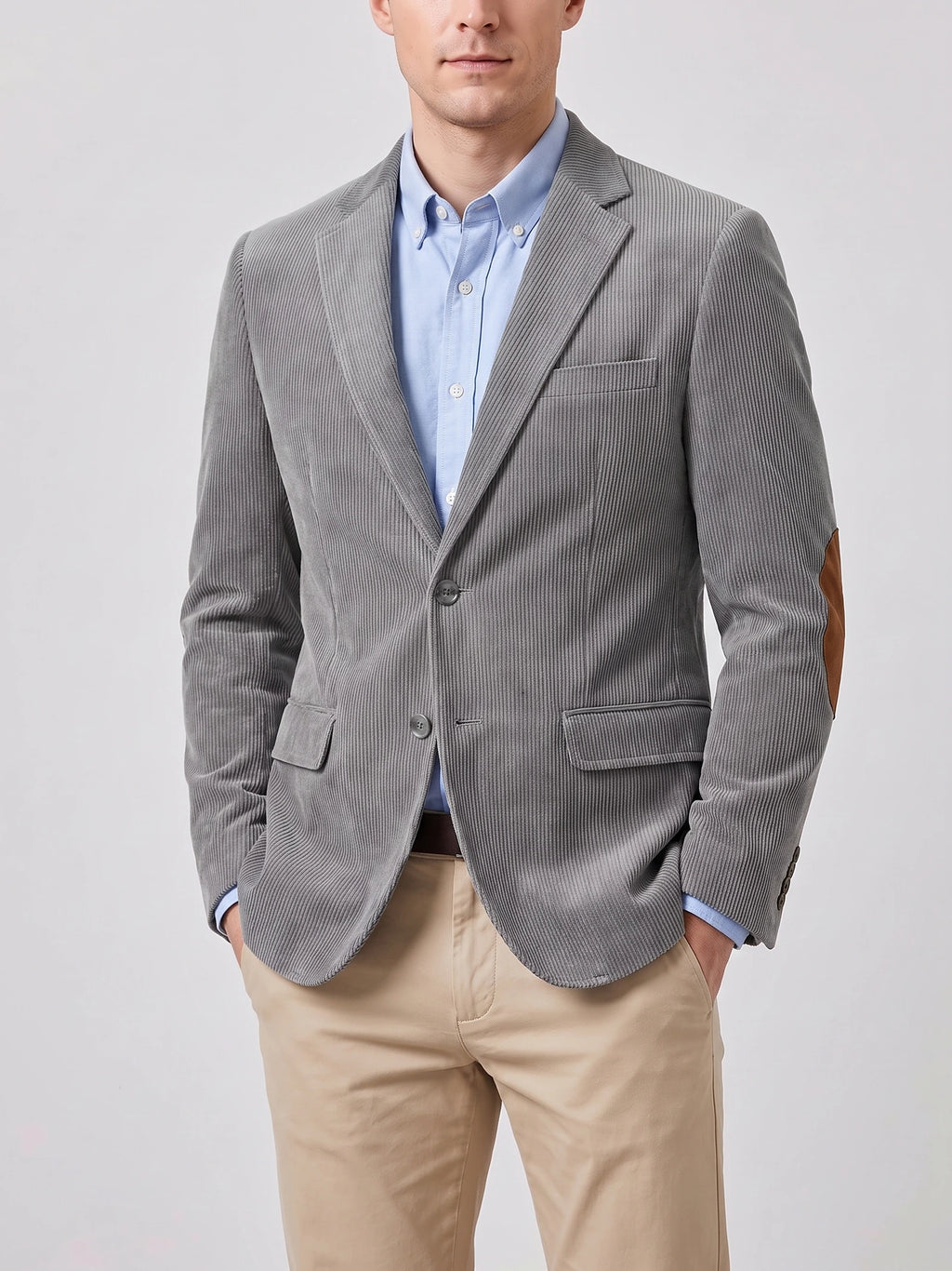 Front studio view of a model wearing a Gray corduroy blazer with notch lapels, flap pockets, and elbow patches.