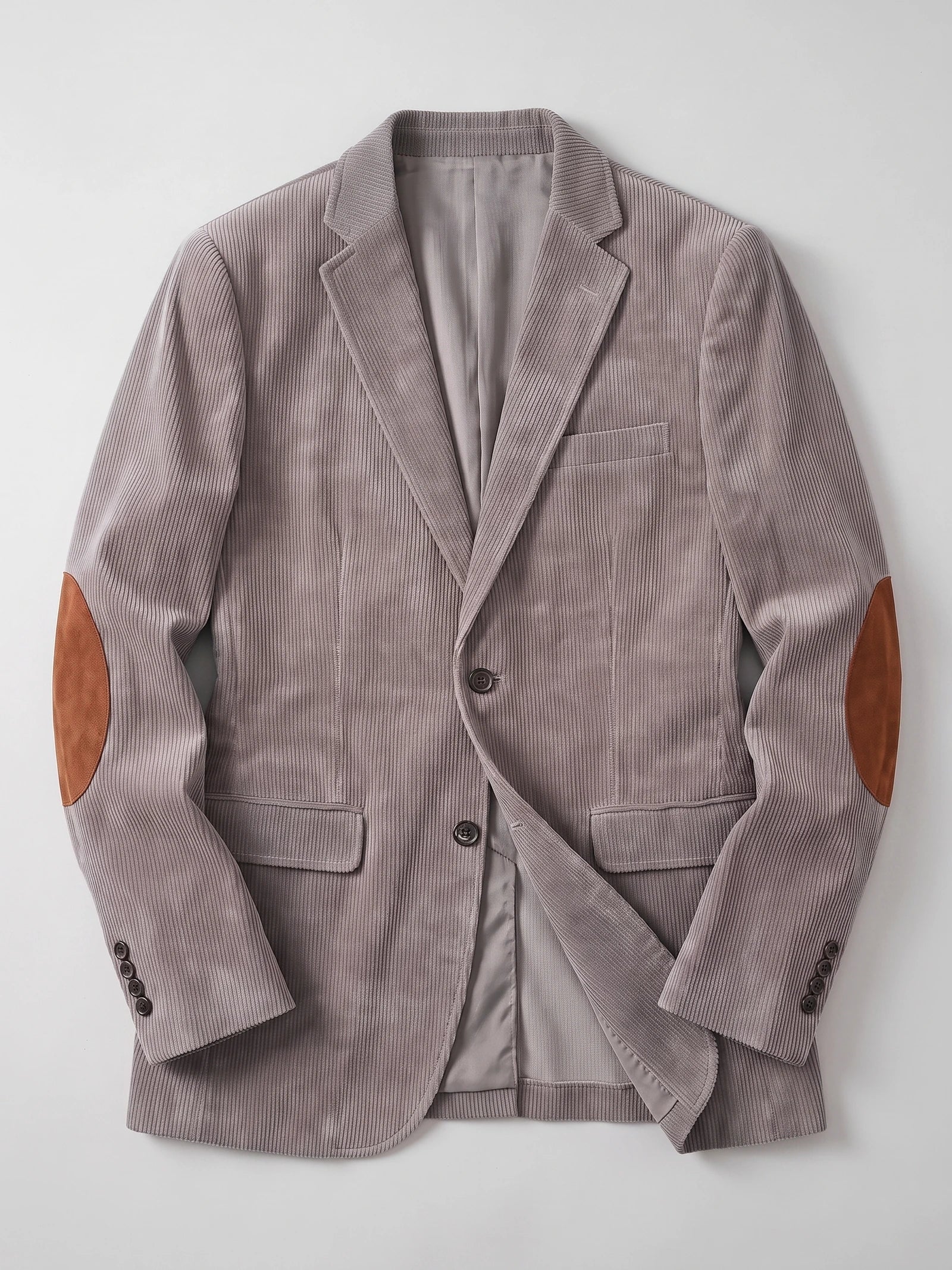 Gray corduroy blazer laid flat, showing notched lapels, flap pockets, button cuffs, and elbow patches.