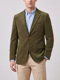 Front studio view of a model wearing a Green corduroy blazer with a notched lapel, flap pockets, and elbow patches.
