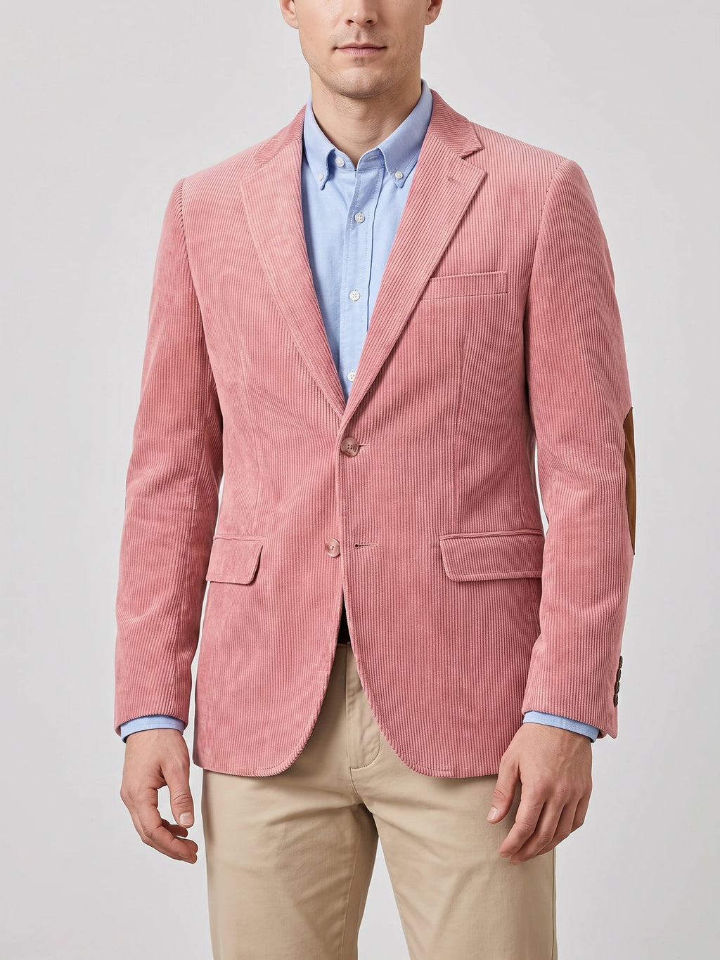 Front studio view of a model wearing a Pink corduroy blazer with notch lapels, flap pockets, two-button closure, and elbow patches.