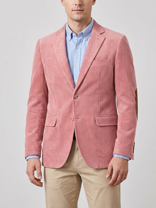 Front studio view of a model wearing a Pink corduroy blazer with notch lapels, flap pockets, two-button closure, and elbow patches.