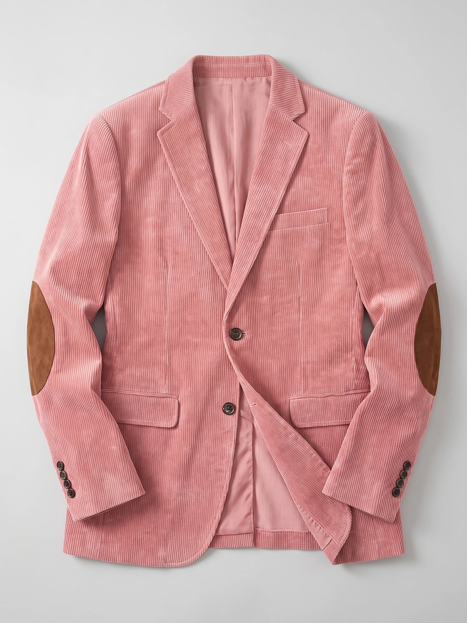 Pink corduroy blazer laid flat, featuring notched lapels, flap pockets, button cuffs, and elbow patches.