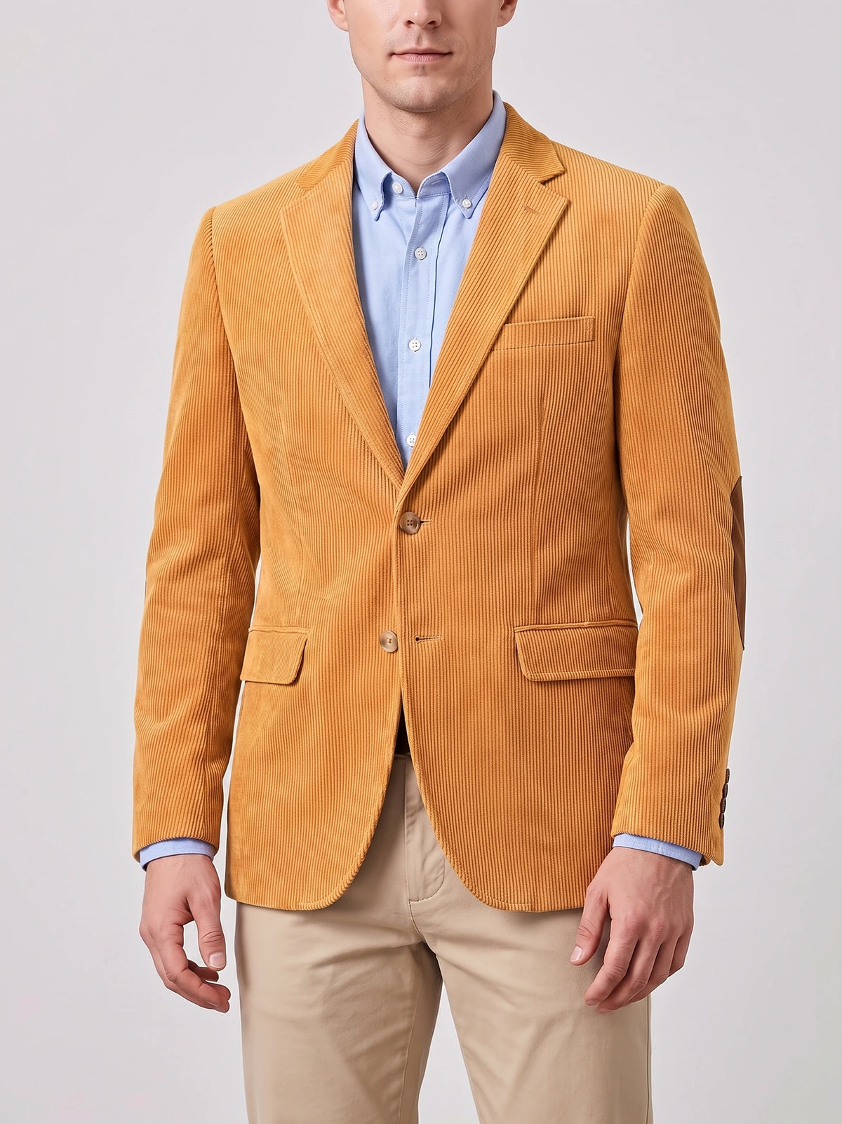 Front studio view of a model wearing a Yellow corduroy blazer with notch lapels, two-button closure, flap pockets, and elbow patches.