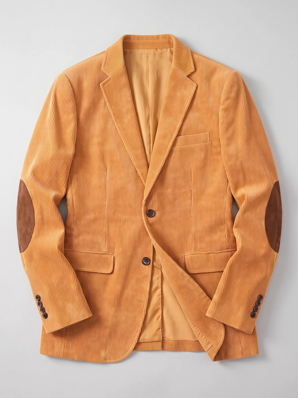 Yellow corduroy blazer laid flat, featuring notched lapels, flap pockets, button cuffs, and elbow patches.