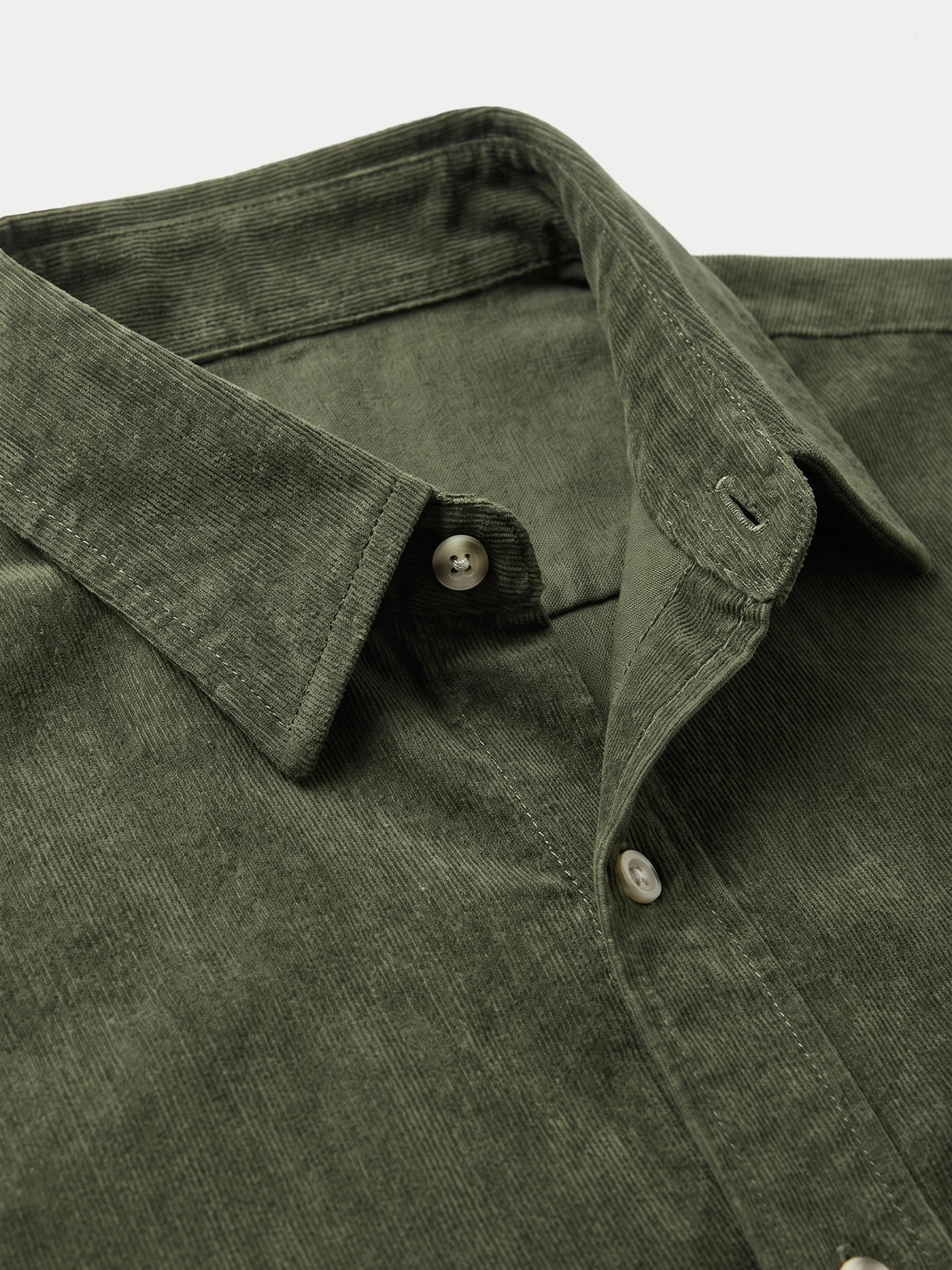Close-up of a Green cotton Corduroy Shirt showcasing the pointed collar, ribbed texture, and button placket.