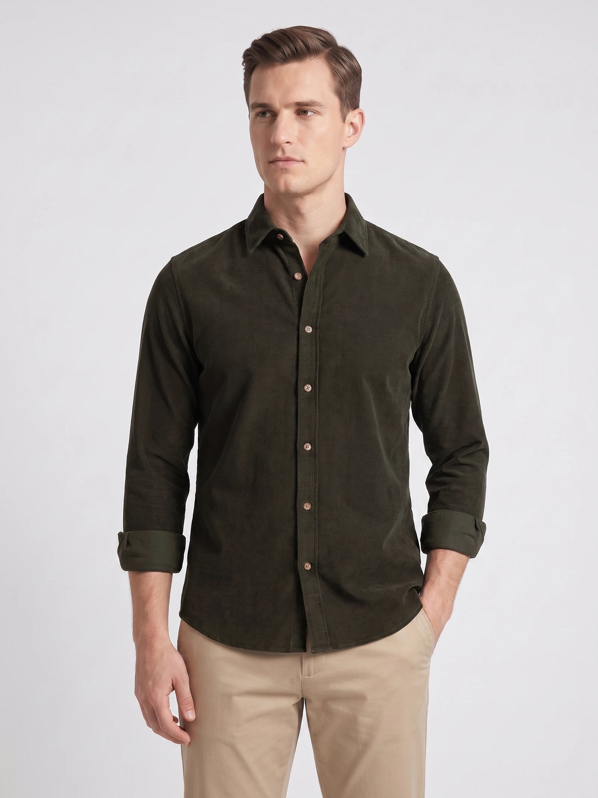 Model wearing a Green cotton corduroy shirt with a pointed collar, button front, and rolled sleeves in a front studio view.