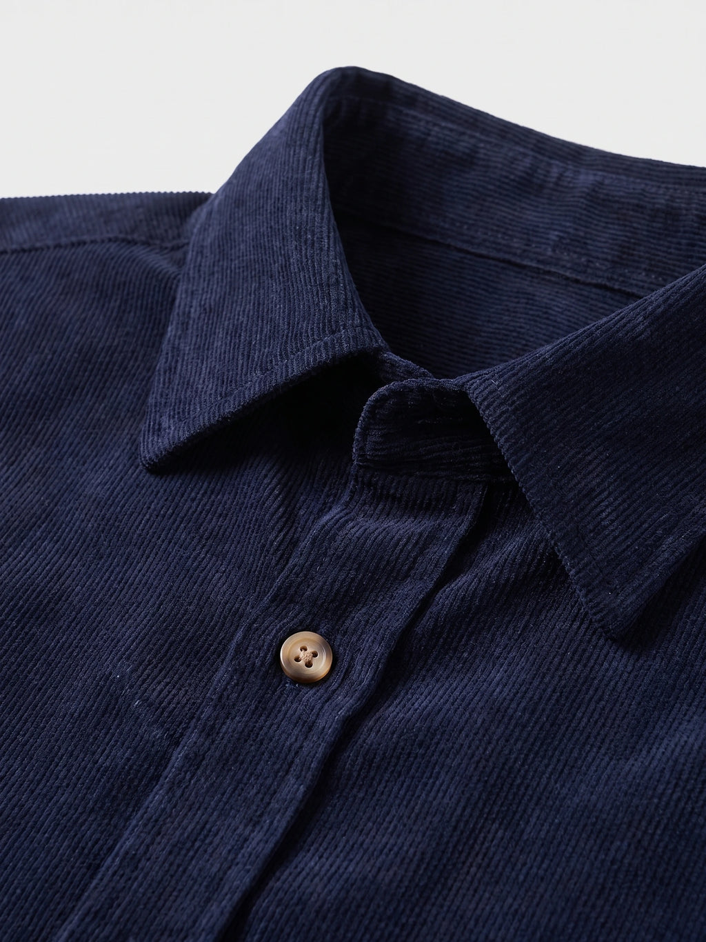 Close-up of the Navy Corduroy Shirt collar, ribbed cotton texture, and front button.