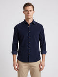 Front studio view of a model wearing a Navy cotton Corduroy Shirt with a button-front collar and rolled sleeves.