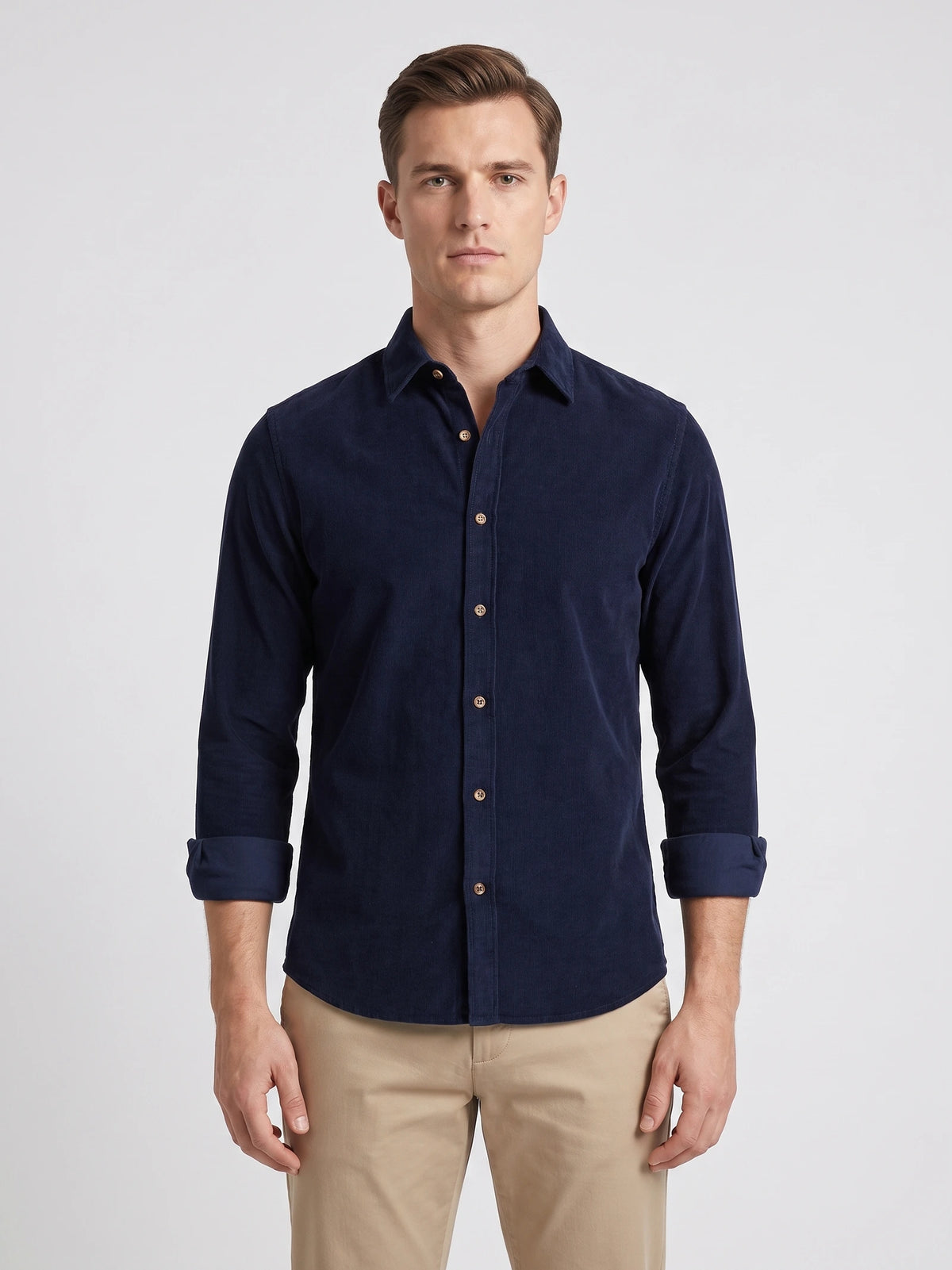 Front studio view of a model wearing a Navy cotton Corduroy Shirt with a button-front collar and rolled sleeves.