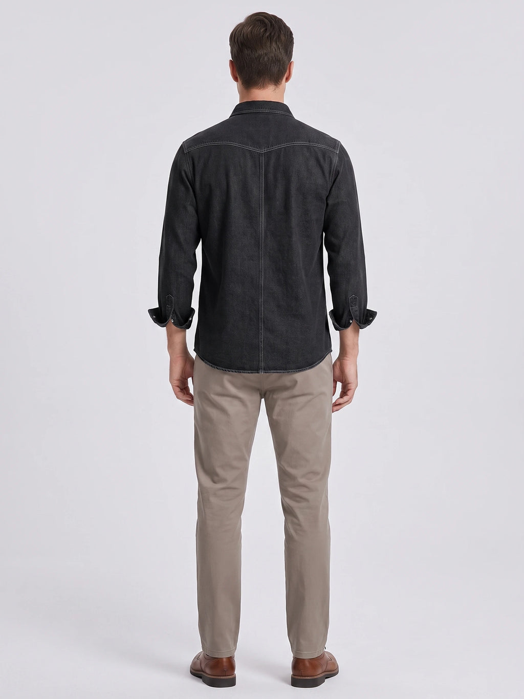 Rear studio view of a model wearing a Black cotton Cowboy Shirt with contrast back yoke and center seam.