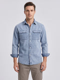 Front studio view of a model wearing a Blue cotton Cowboy Shirt with snap buttons and two flap chest pockets.
