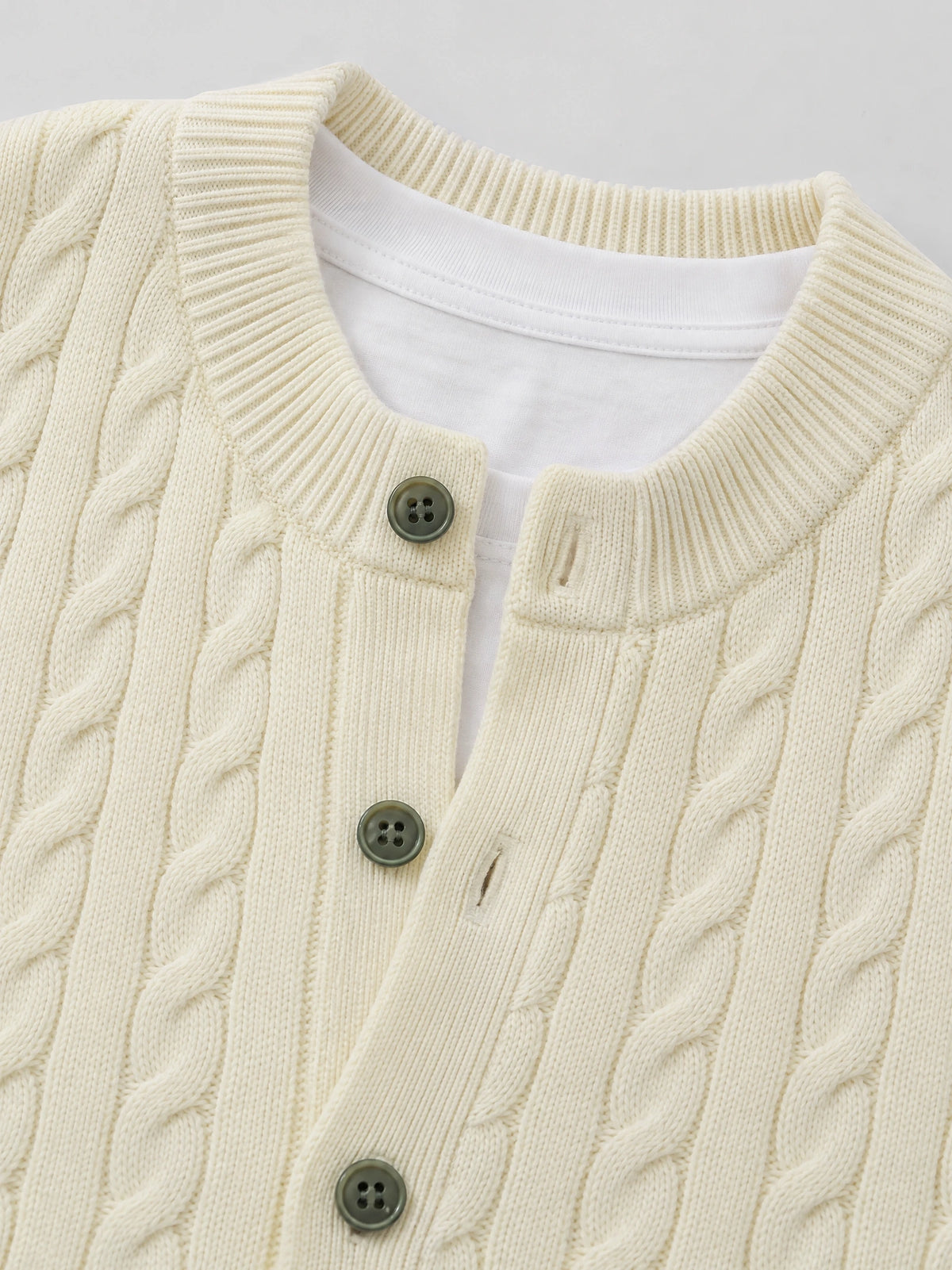 Beige crewneck cardigan close-up showing cable-knit texture, ribbed trim, and front button closure.