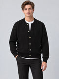 Front studio view of a model wearing a Black crewneck cardigan with cable-knit texture, button front, and ribbed trim.