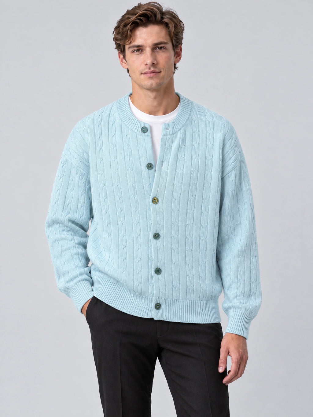 Front studio view of a model wearing a Blue crewneck cardigan with cable-knit texture, button front, and ribbed trim.