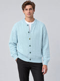 Front studio view of a model wearing a Blue crewneck cardigan with cable-knit texture, button front, and ribbed trim.