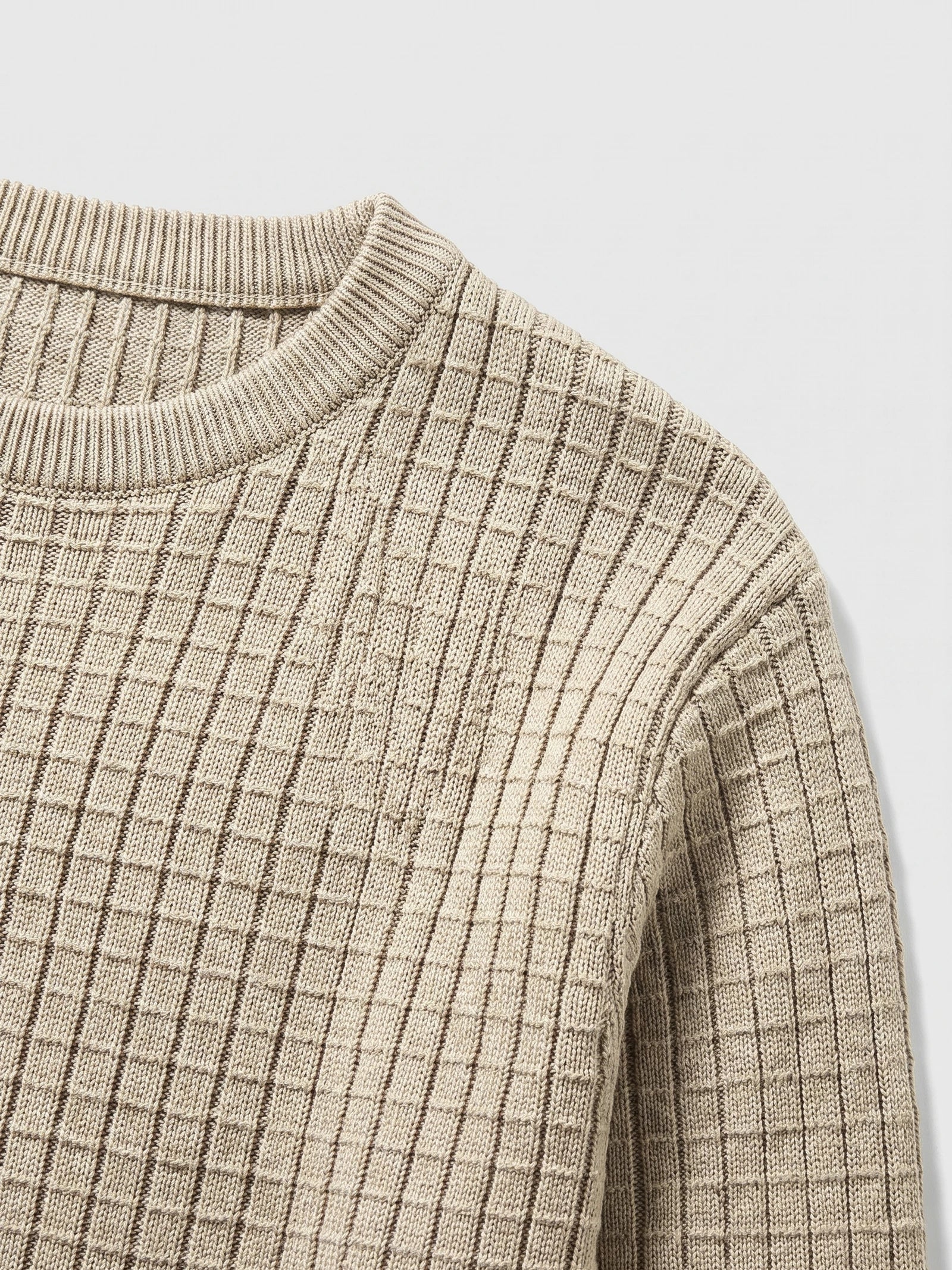 Close-up of the ribbed crew neckline and textured vertical knit pattern on a Beige men's crewneck sweater.