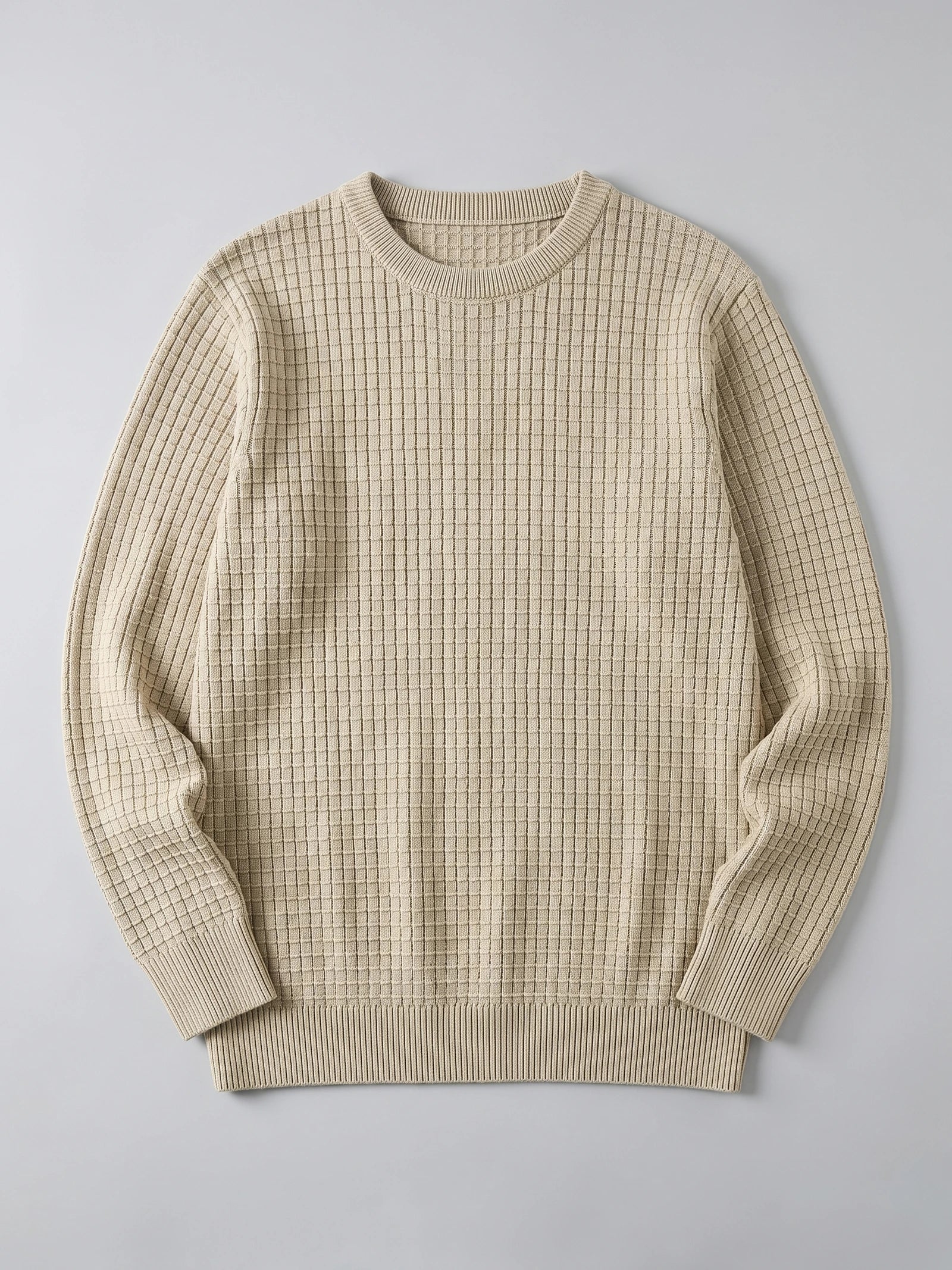 Beige men’s crewneck sweater laid flat, featuring a textured grid knit and ribbed collar, cuffs, and hem.
