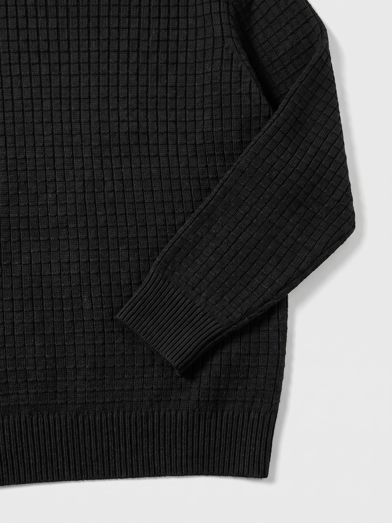 Black Men's Crewneck Sweater detail showing textured knit fabric, a ribbed cuff, and hem.