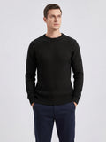 Front studio view of a model wearing a Black men's crewneck sweater with textured grid knit and ribbed trim.